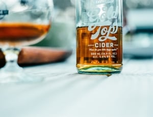 gold top cider bottle on top of white surface thumbnail