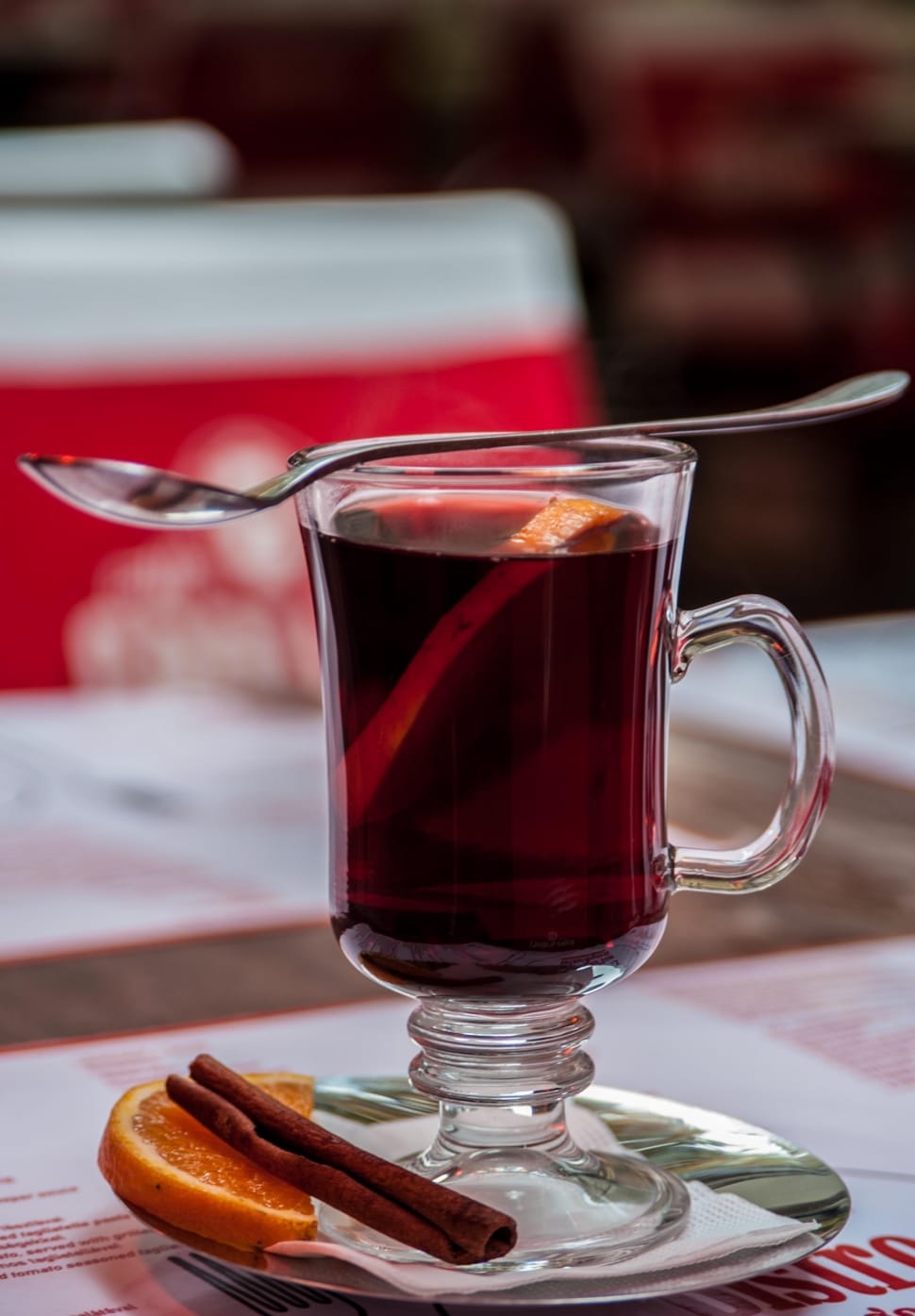 clear turkish teacup filled with tea with spoon on top \ preview