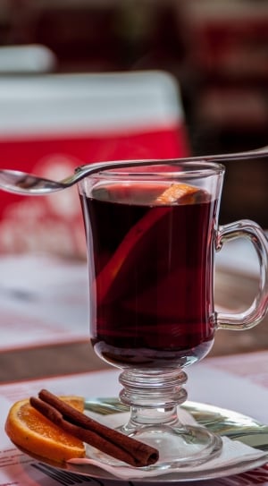 clear turkish teacup filled with tea with spoon on top \ thumbnail