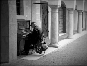man playing piano gray scale portrait thumbnail