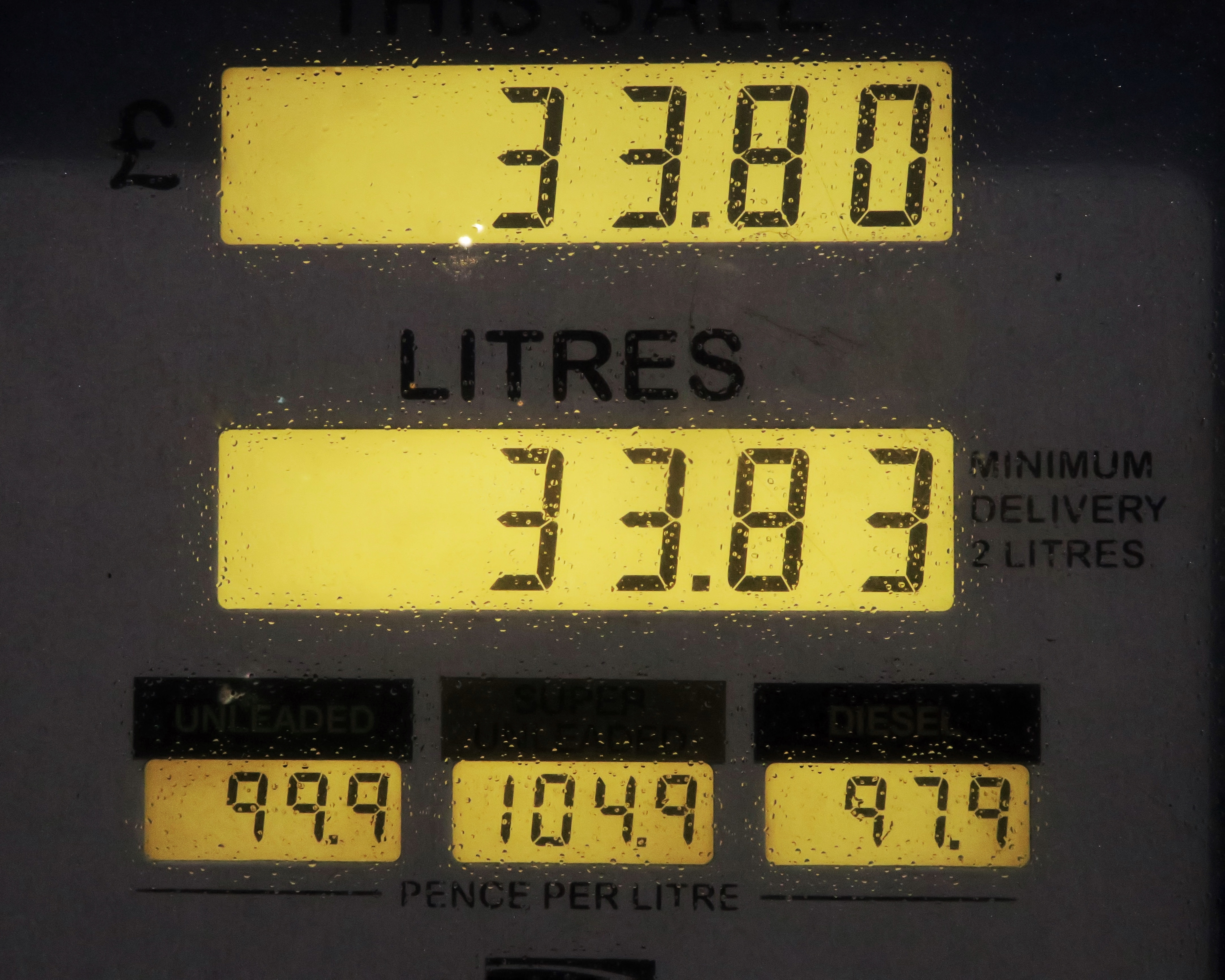 black gasoline station monitor at 33.80 and 33.83 litter 99.9 104.9 97.9 pence per litre