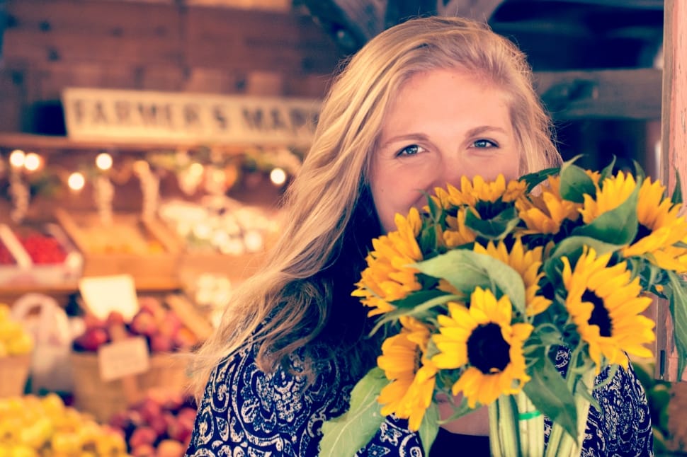 woman holding bunch of sunflowers preview
