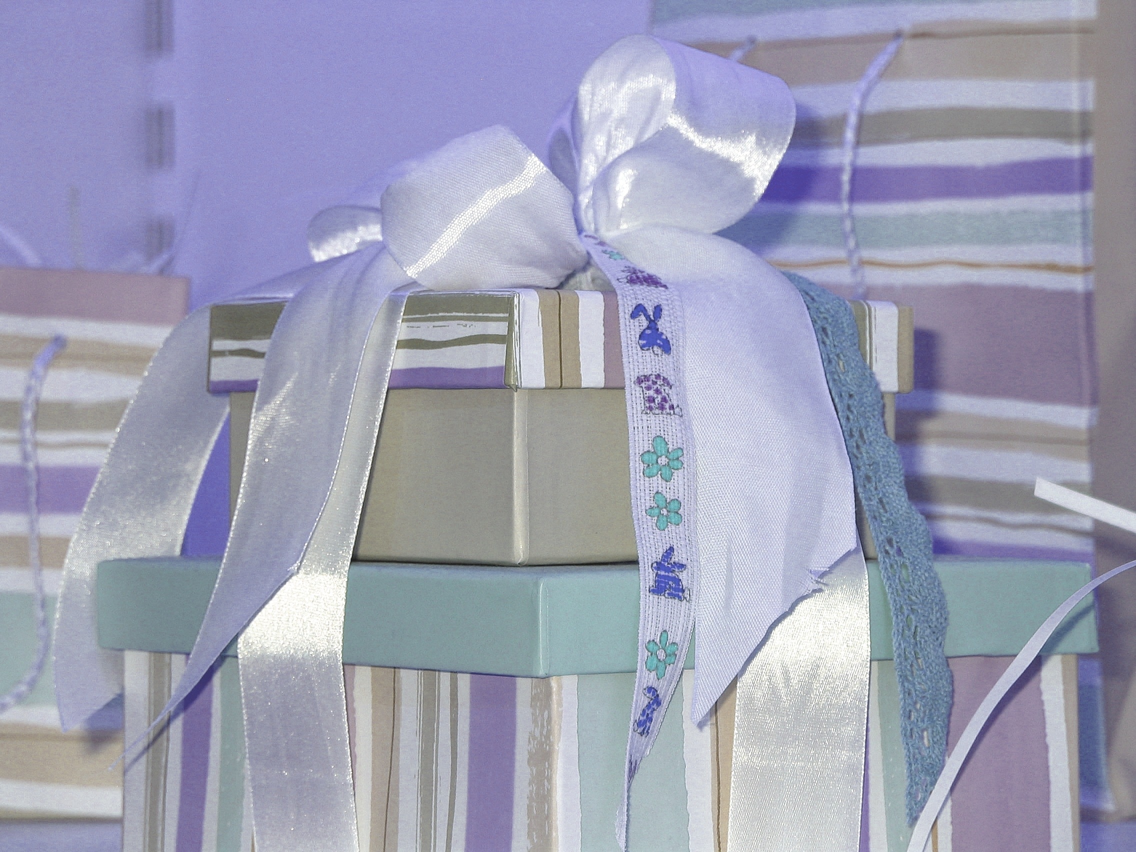 white beige and purple box with ribbon