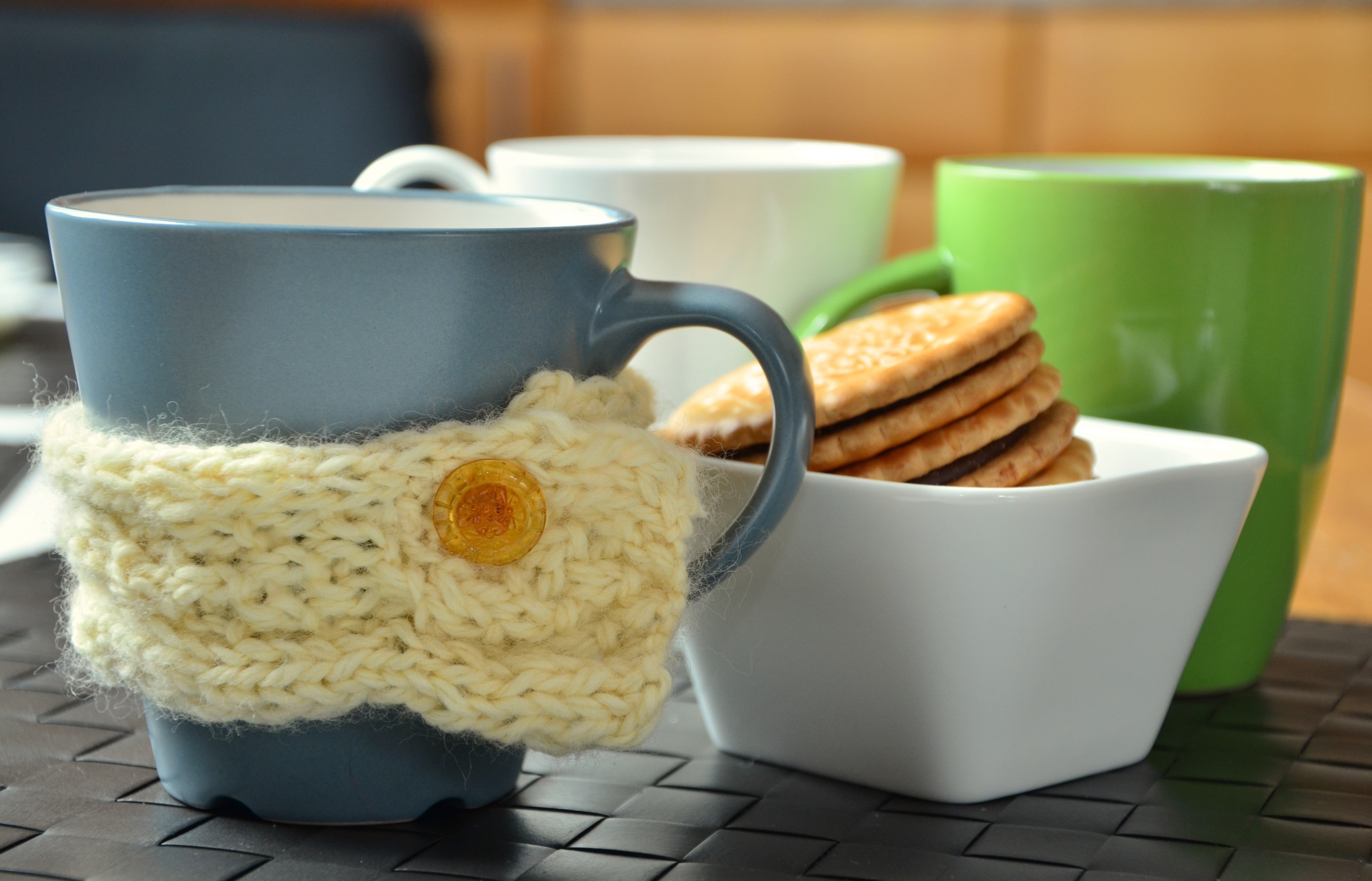 ceramic mugs set and bowl of biscuits