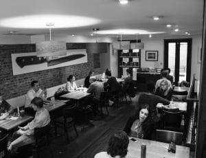 gray scale photo of people in restaurant thumbnail
