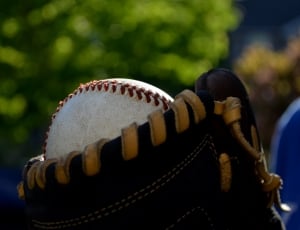 white and red baseball with mitt thumbnail
