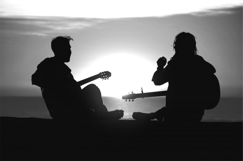 silhouette photo of 2 men playing guitar preview