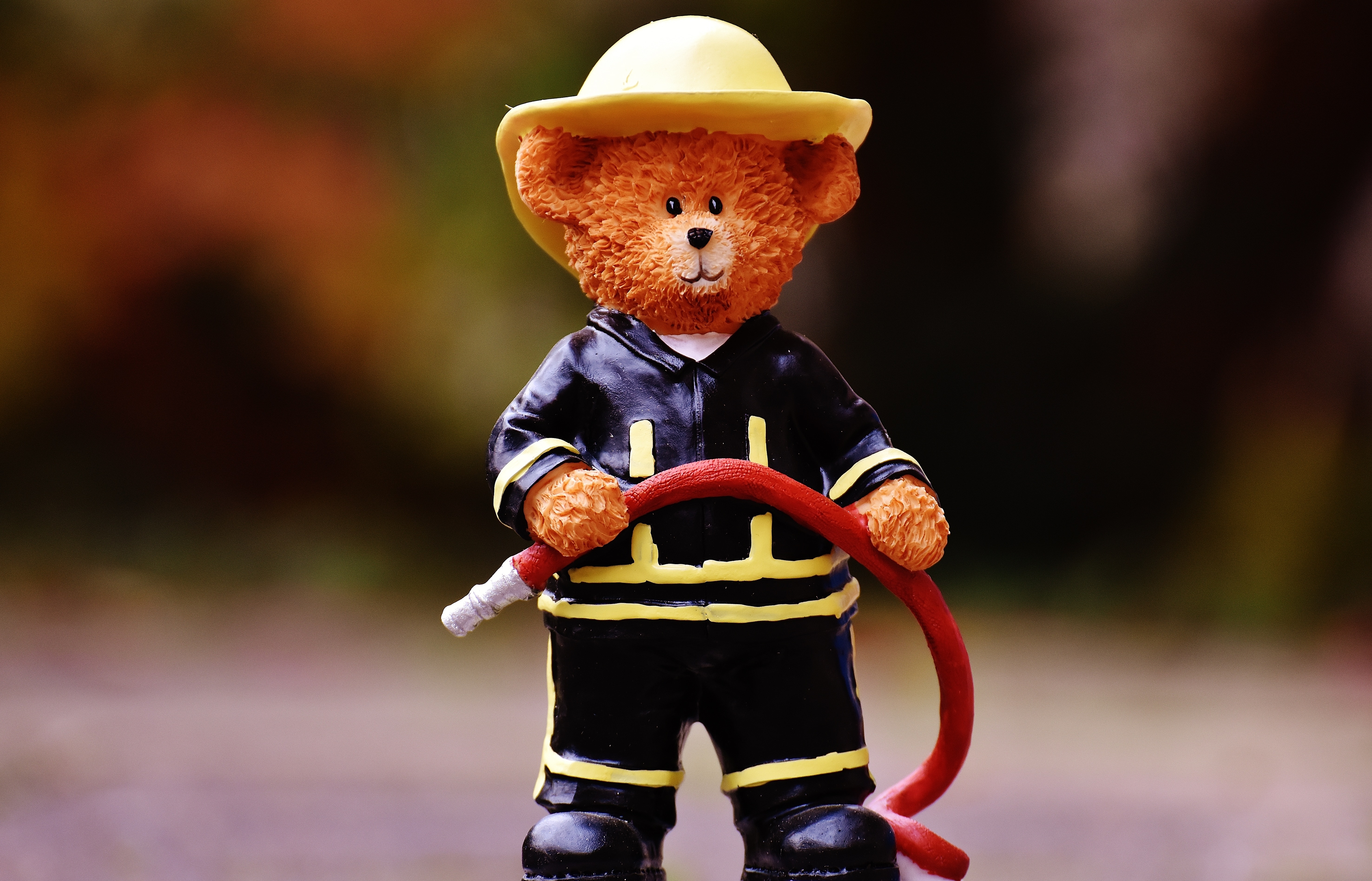 bear in black fireman suit figurine