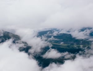 aerial photography of green mountains with white clouds thumbnail