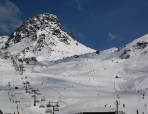 cable car above the snow mountain under blue sky thumbnail
