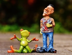 man and frog ceramic figurine thumbnail