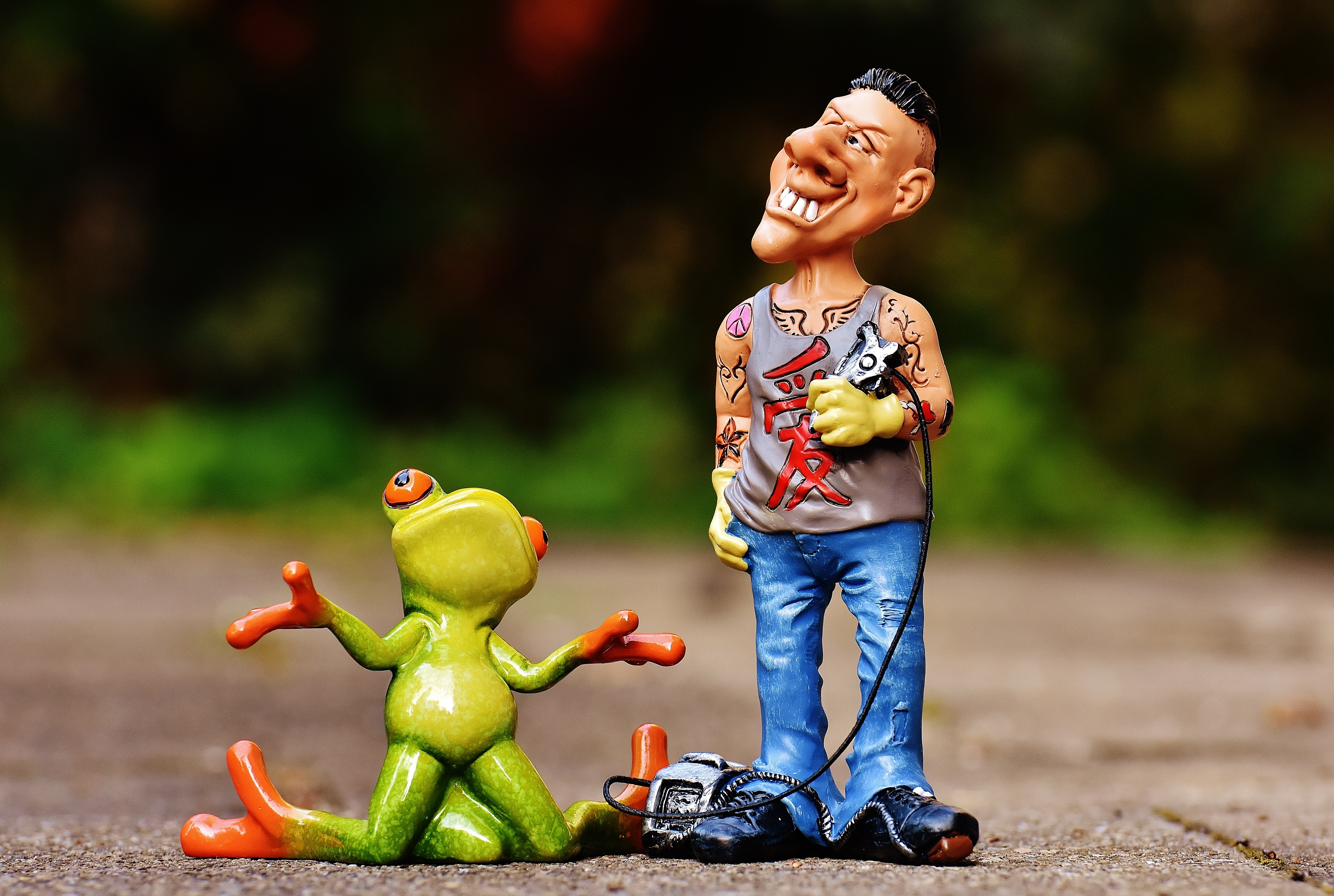 man and frog ceramic figurine