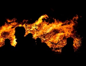 silhouette of people near fire thumbnail