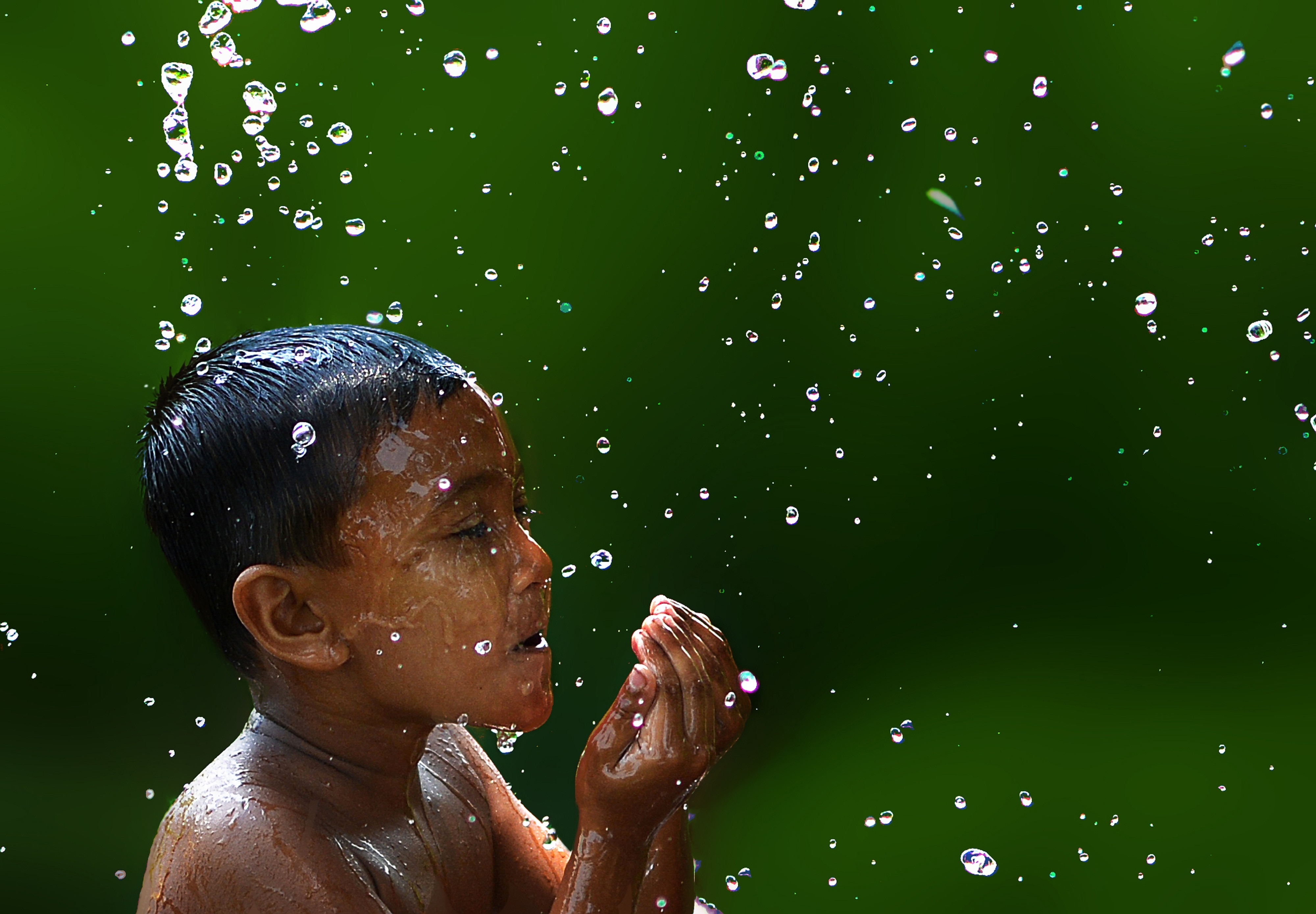 photo of boy with water droplets