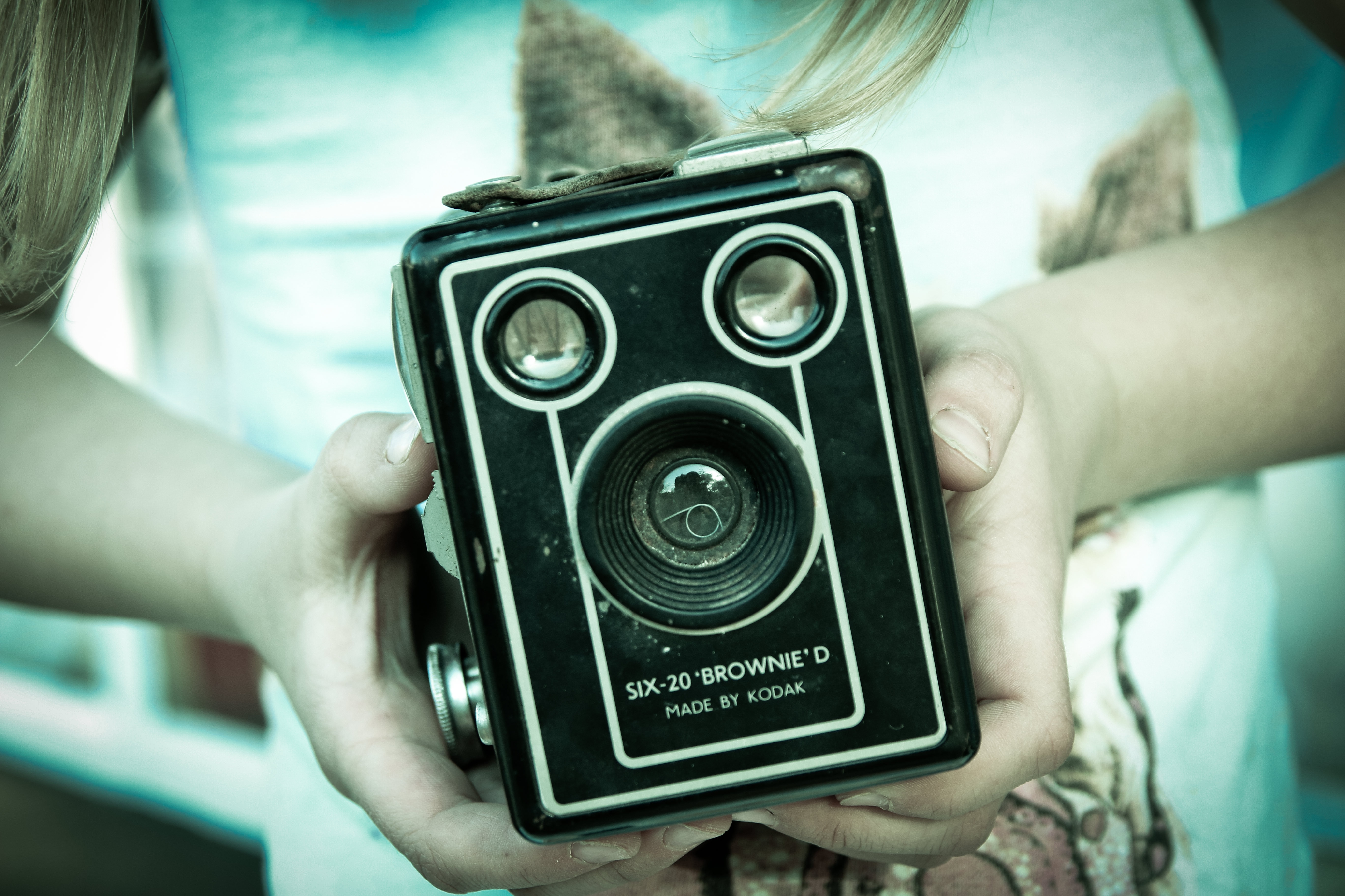 person holding black six 20 brownie device
