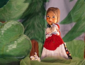 brown haired girl with red and white maxi dress wooden sculpture thumbnail