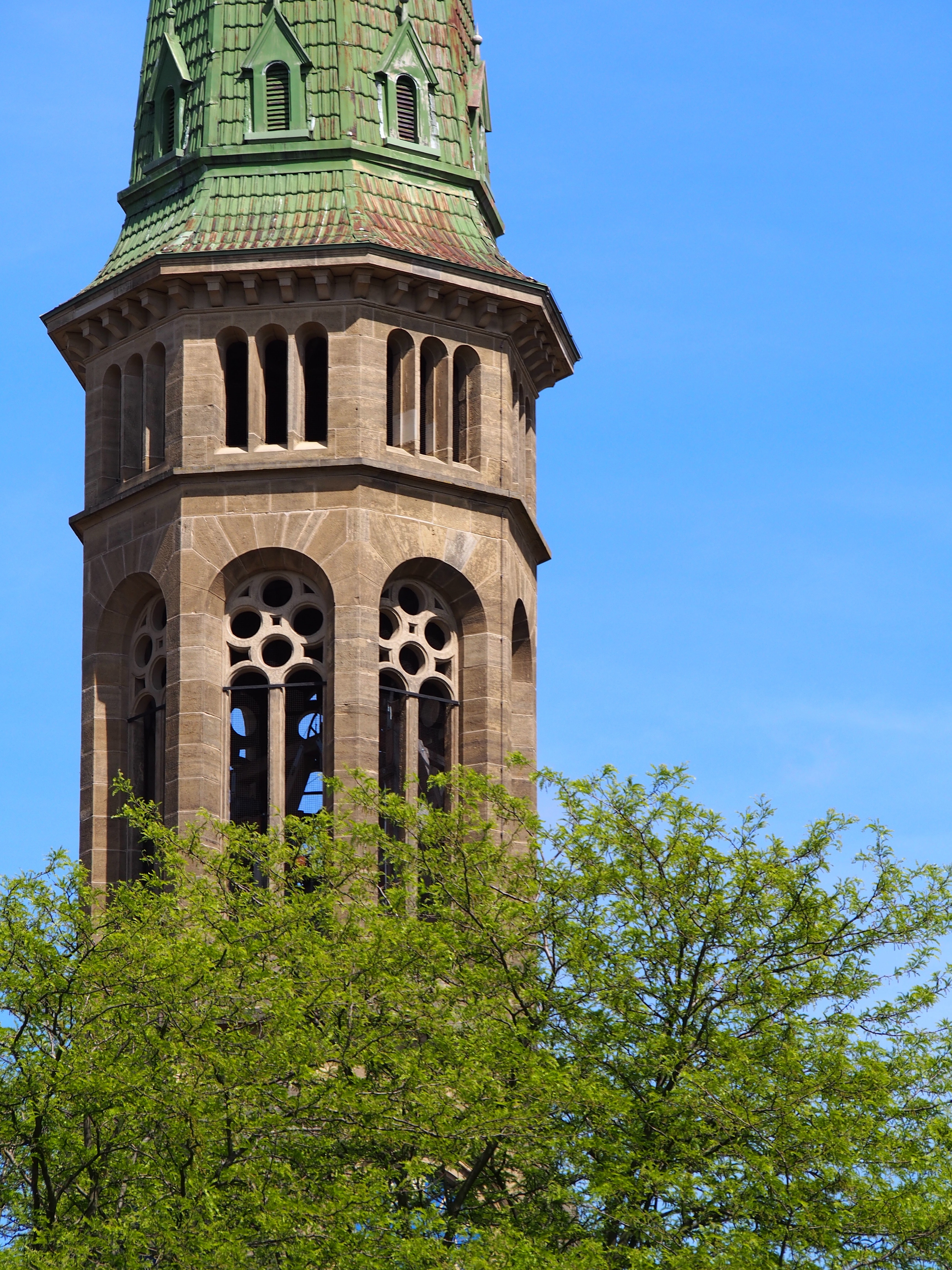 photograph of brown and green tower
