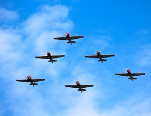 six stunt planes forming triangle in the air thumbnail