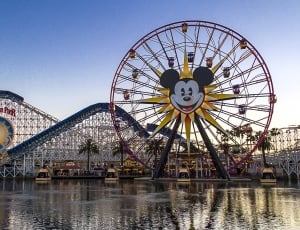 Mickey Mouse themed ferris wheel near body of water during daytime thumbnail