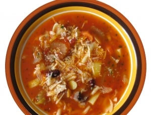 orange soup serve on brown and black ceramic bowl thumbnail