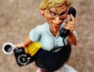 woman answering black telephone caricature figurine thumbnail