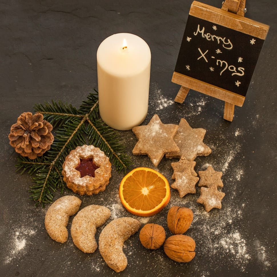 white pillar candle, orange slice, and cookie preview