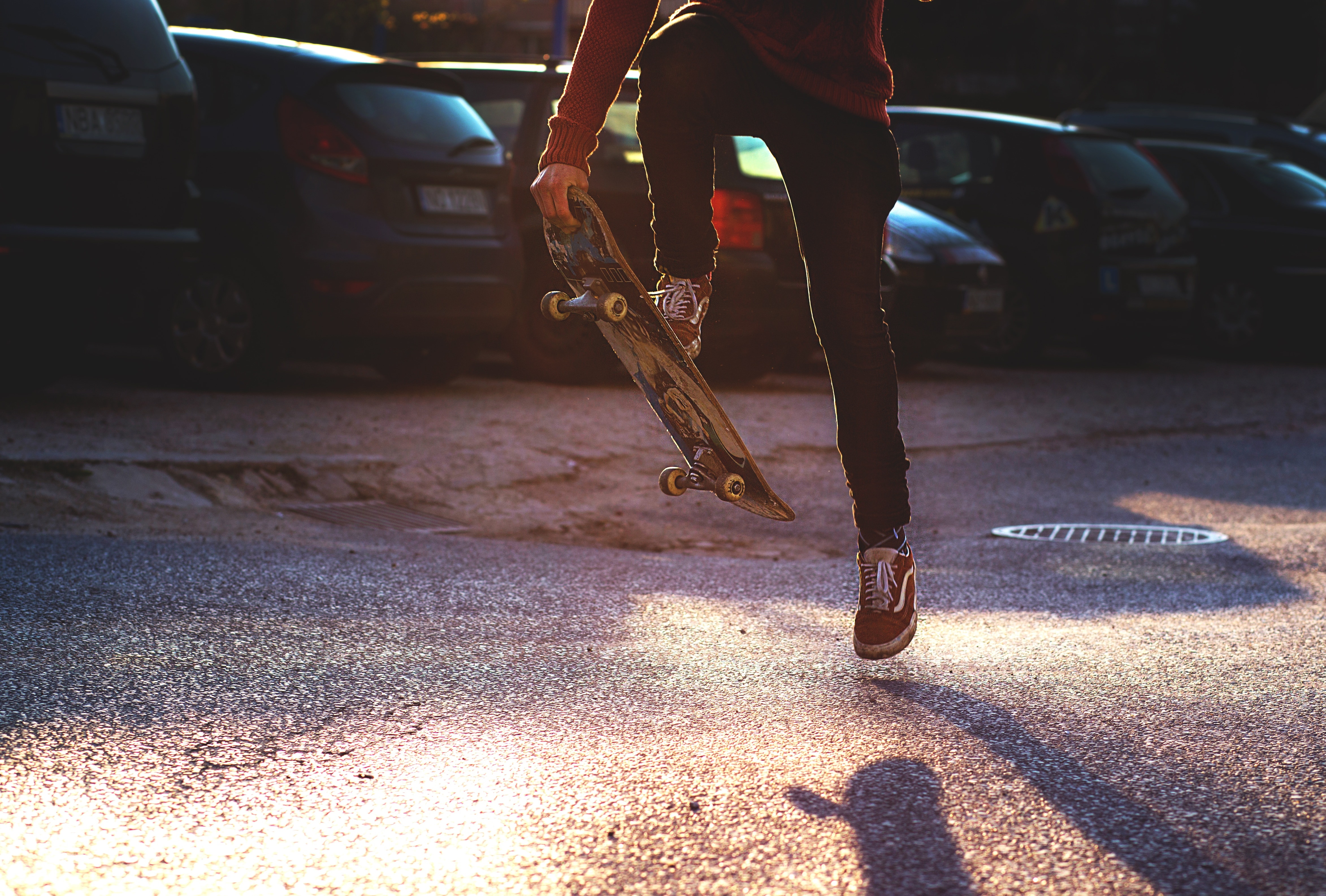 men's red skater shoes and skateboard