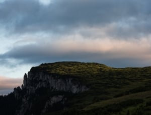landscape photograph of cliff during cloudy skies thumbnail