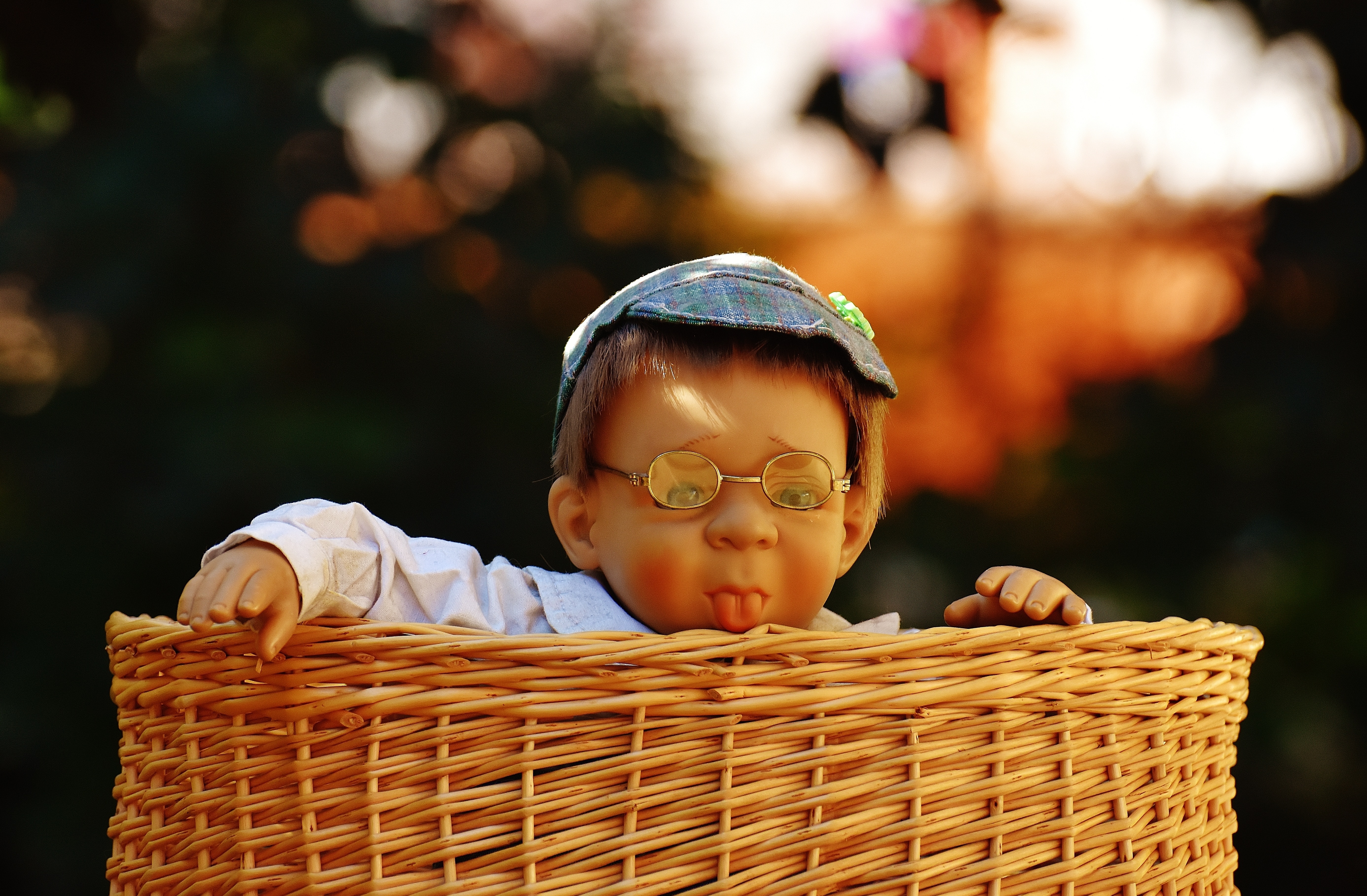 brown wicker basket with boy doll