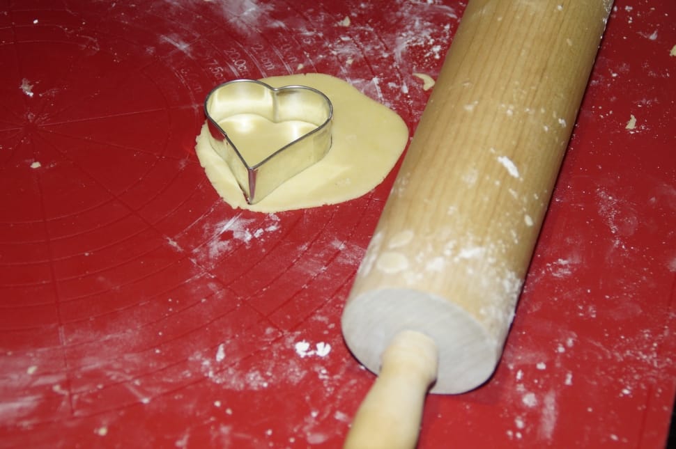 brown rolling pin with stainless steel heart shaped molder preview