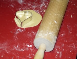 brown rolling pin with stainless steel heart shaped molder thumbnail