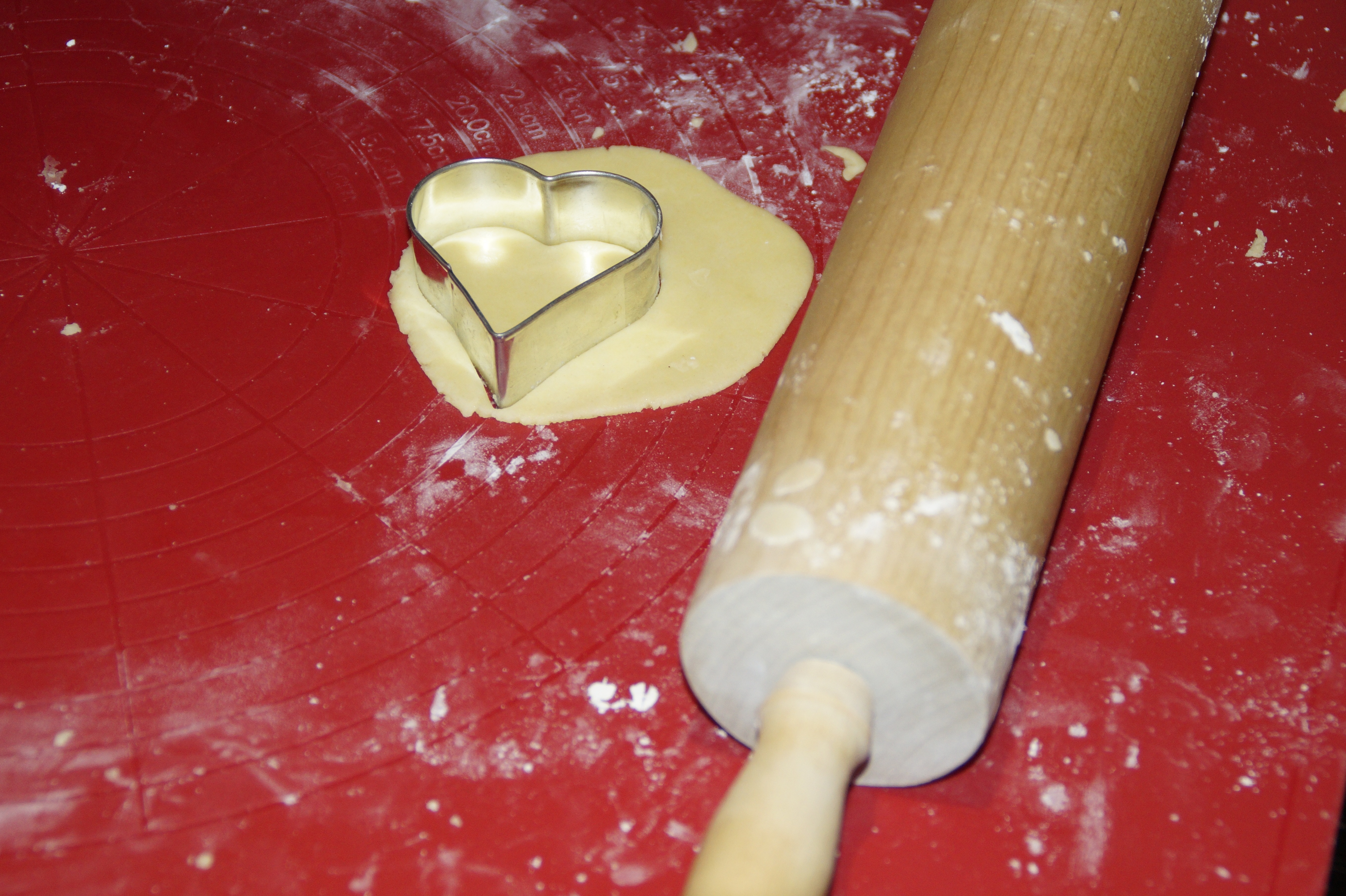brown rolling pin with stainless steel heart shaped molder