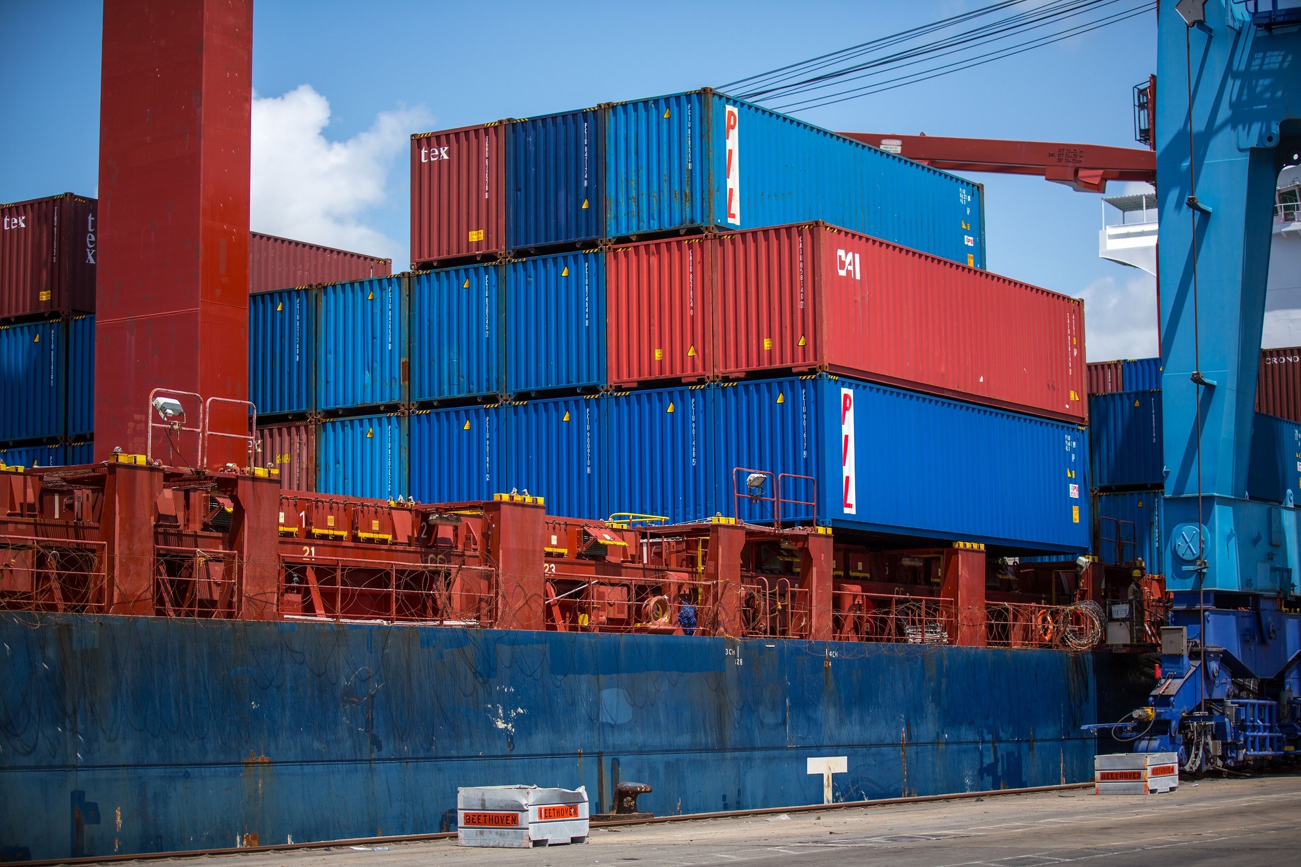 red and blue intermodal containers pile