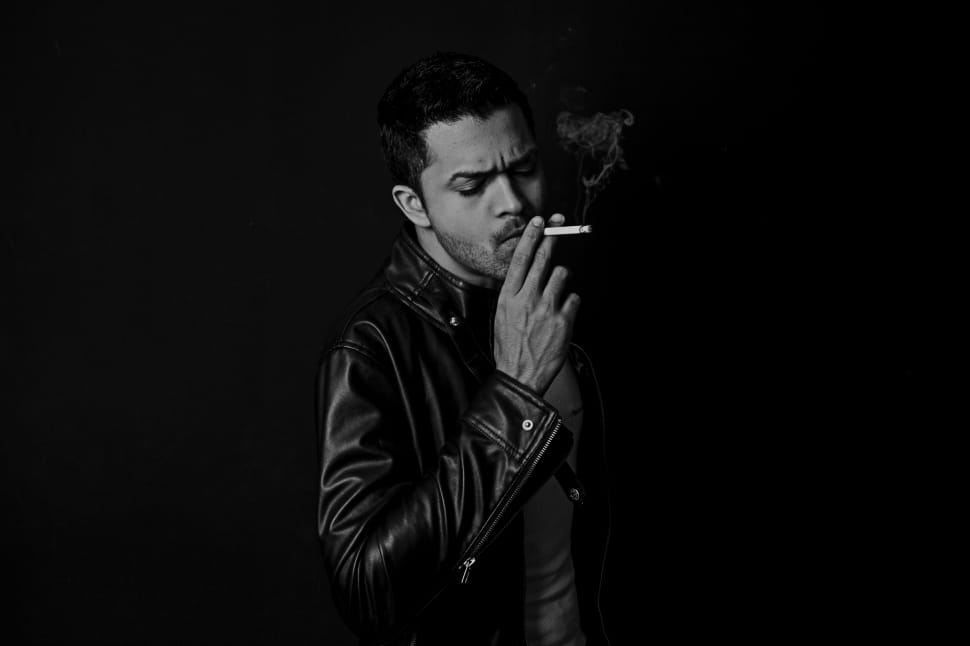 man in black leather jacket smoking cigarette preview