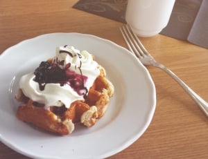 photo of waffle with cream and blue berry syrup thumbnail