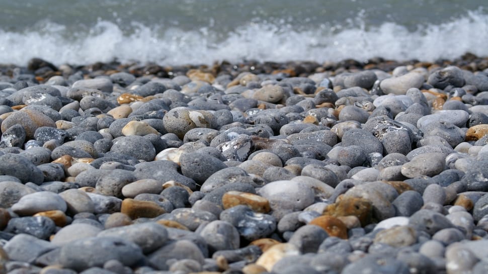 photo of gray stones near seashore preview