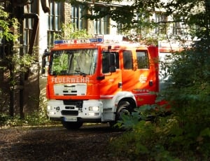 red Feuerwehr firetruck beside building during daytime thumbnail