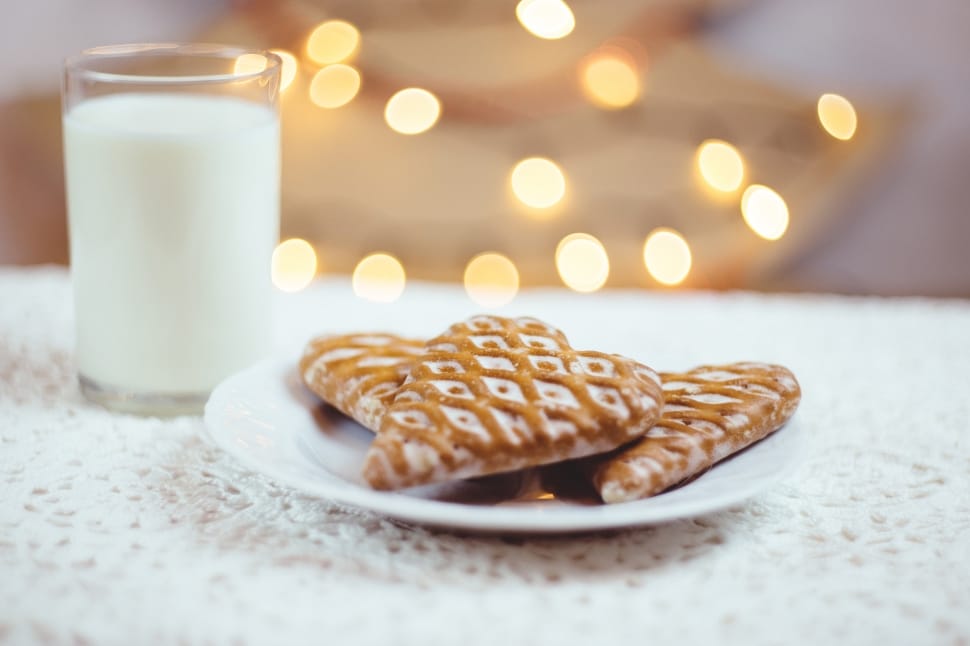 white ceramic plate with three heart shape cookies beside glass of milk preview