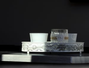 white and clear glass container on oval tray thumbnail