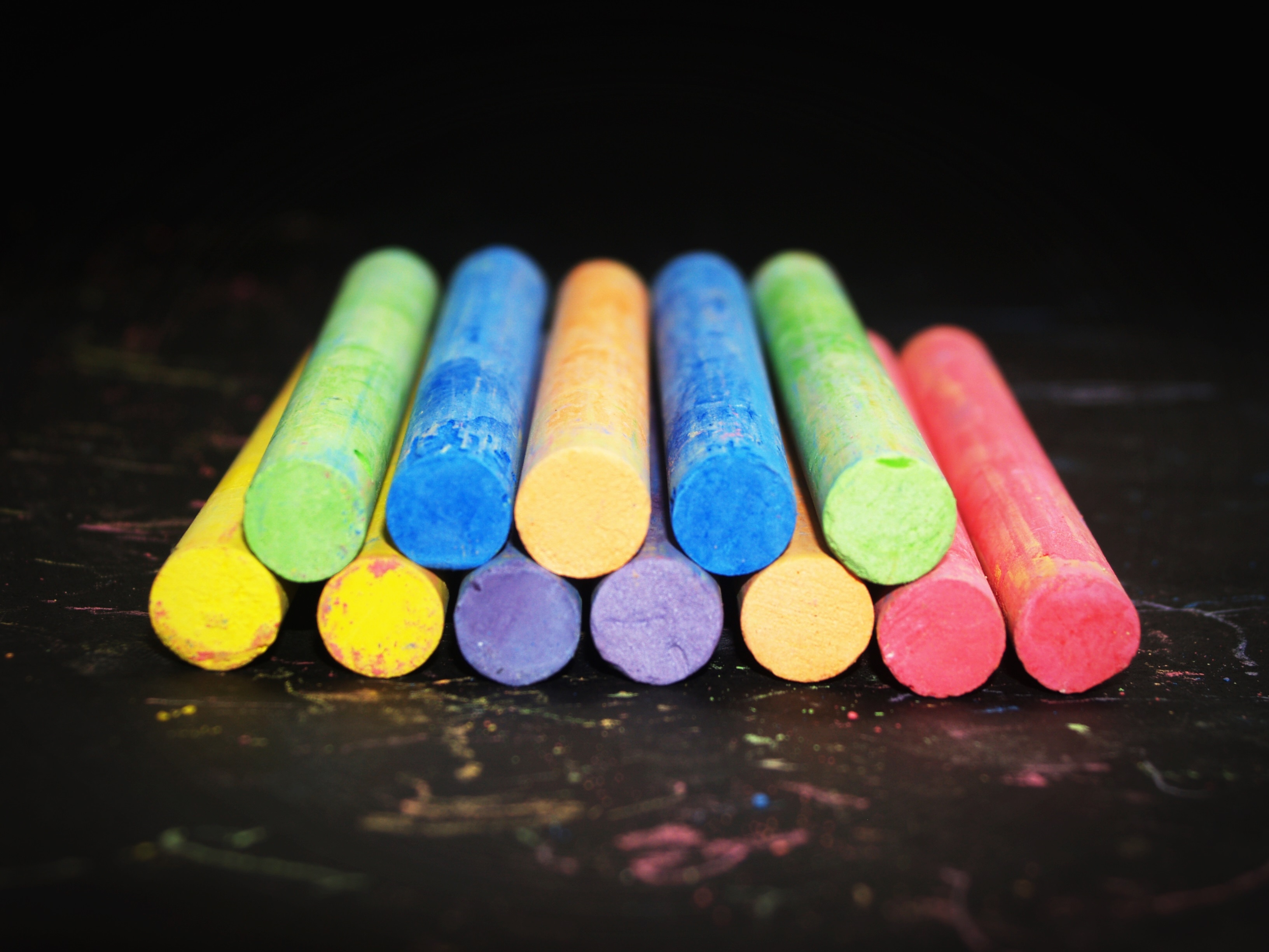 assorted colors of chalks on wood