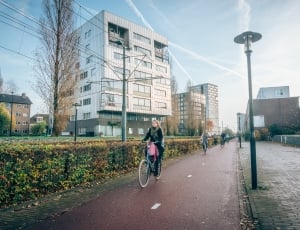 woman riding on blue bicycle thumbnail
