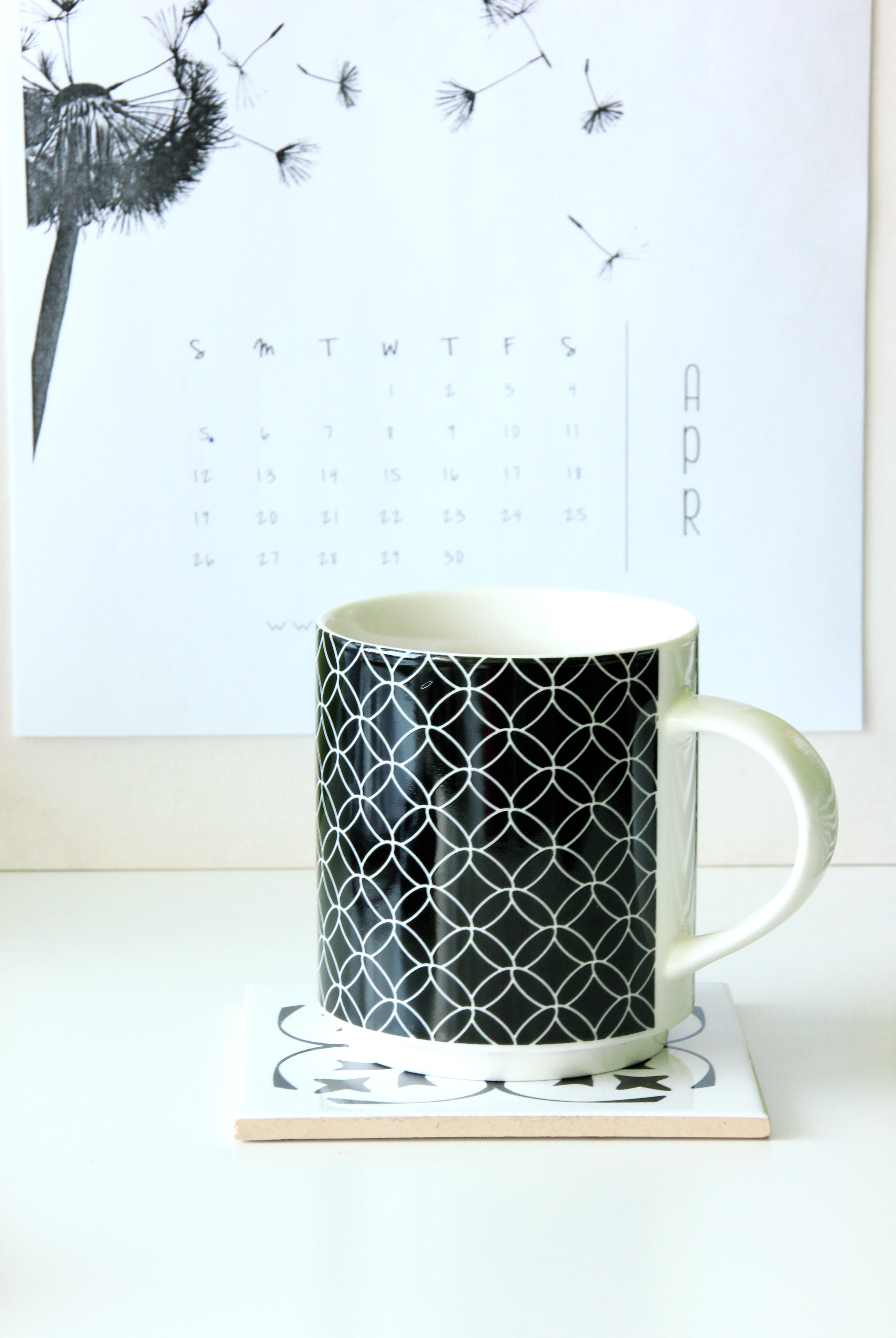 white and black ceramic mug