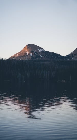 Brown and Black Mountain Near Lake during Day Time thumbnail