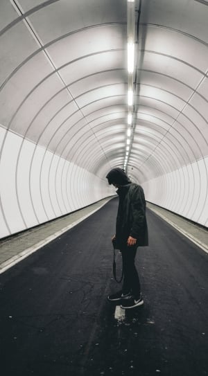man standing in gray tunnel thumbnail