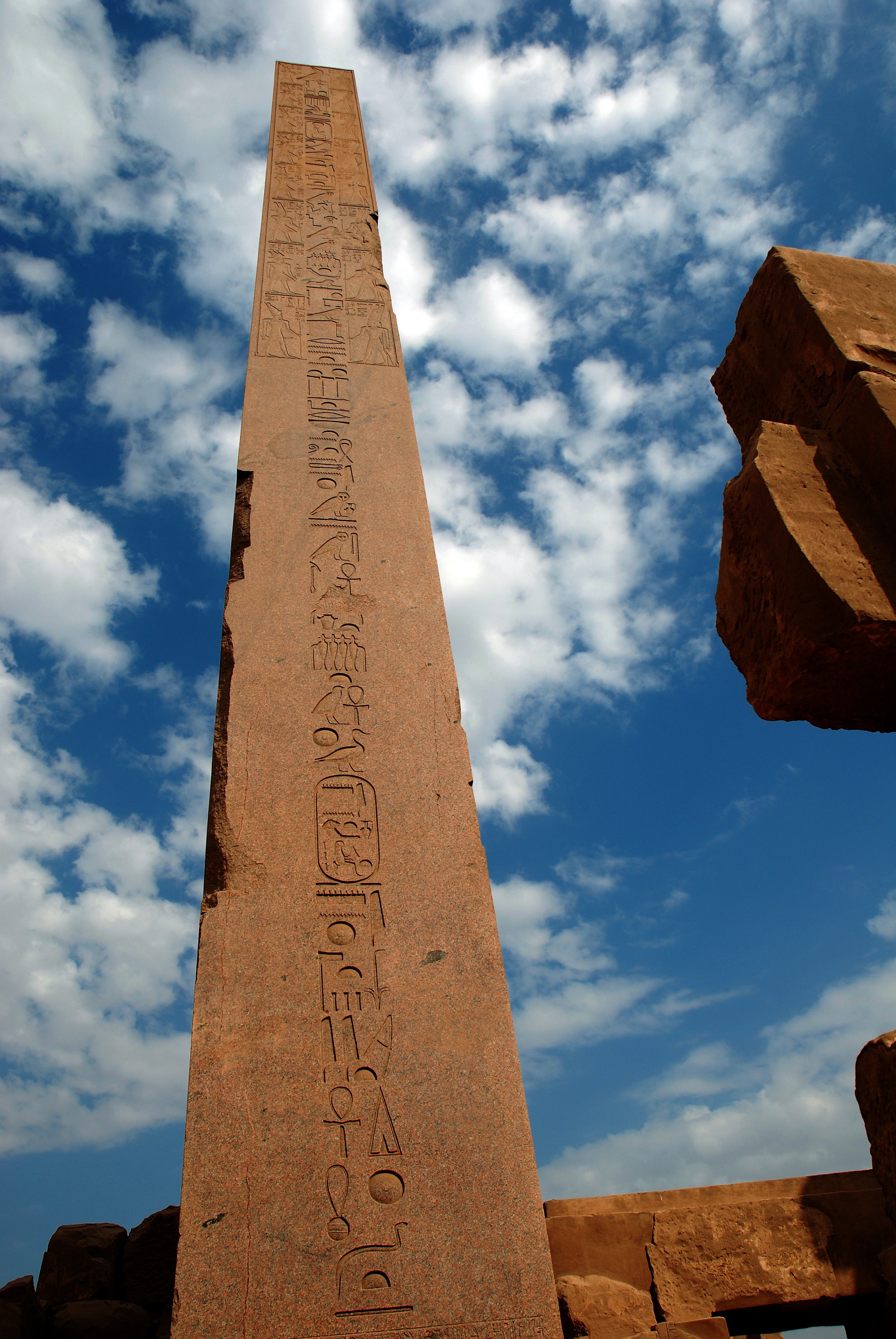 brown concrete tower with hieroglyphics embossed