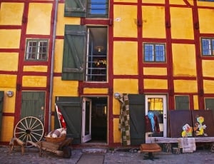 red and yellow painted residential building thumbnail