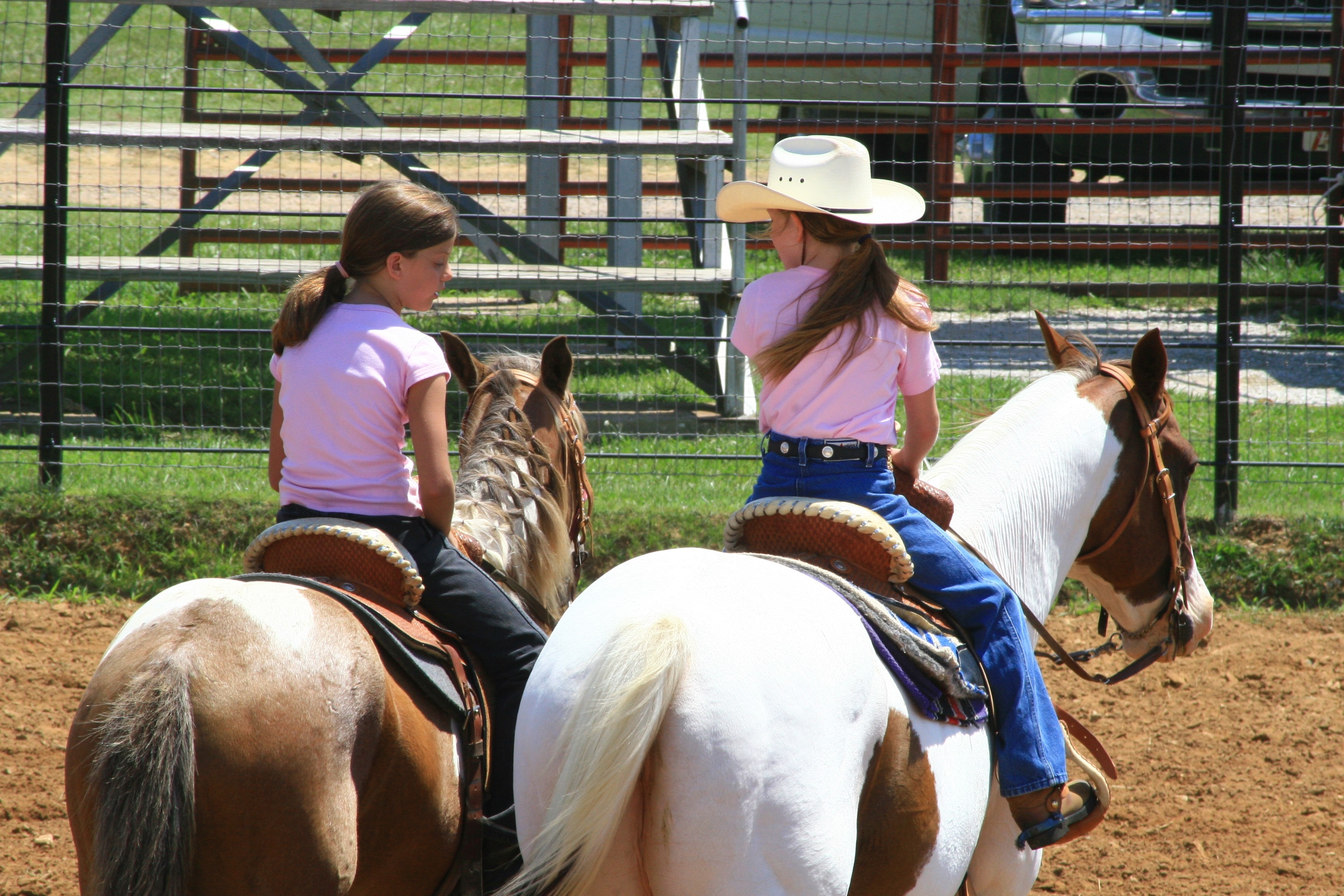 two girls riding horses at daytime