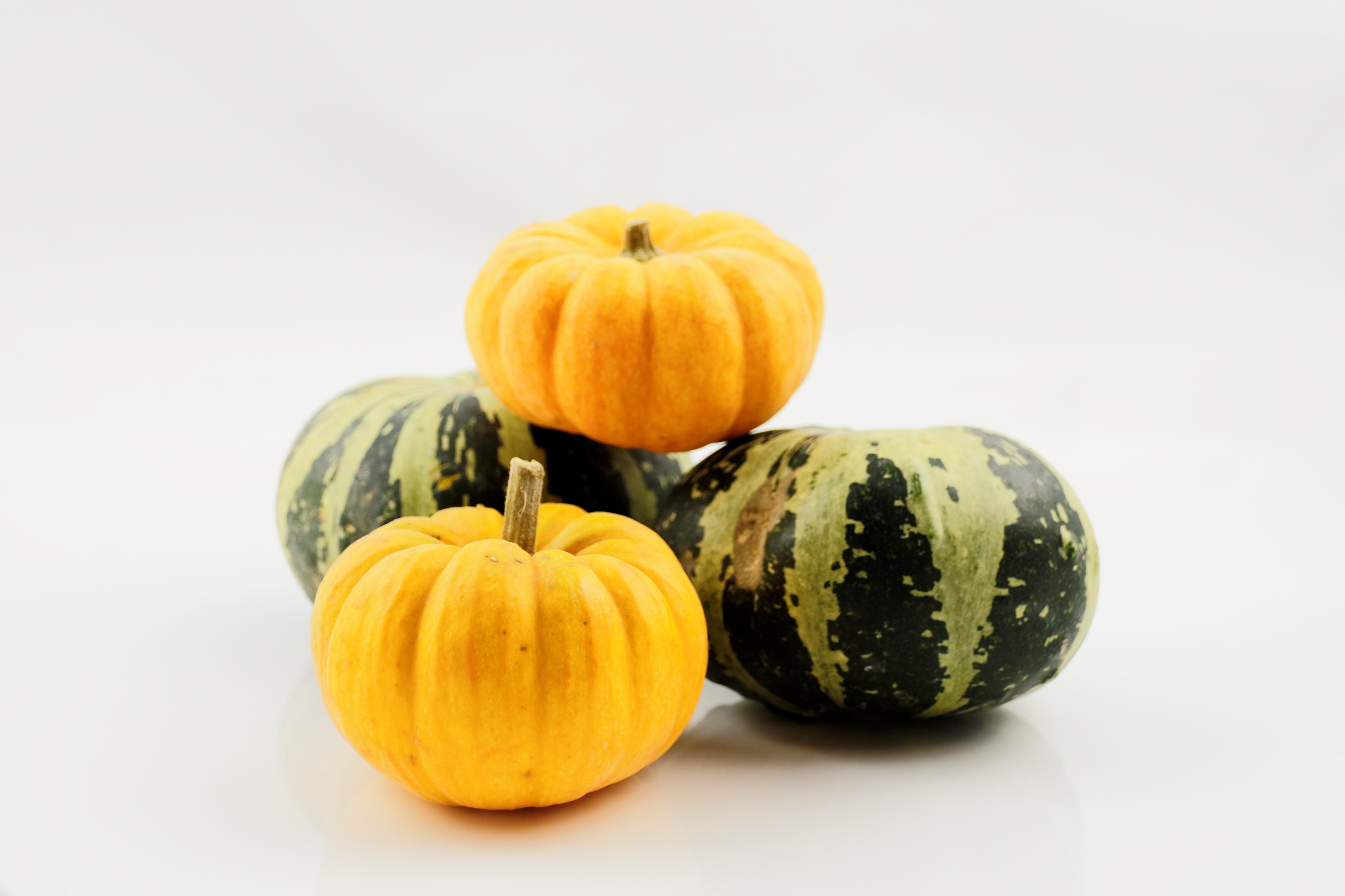 four green and yellow pumpkins