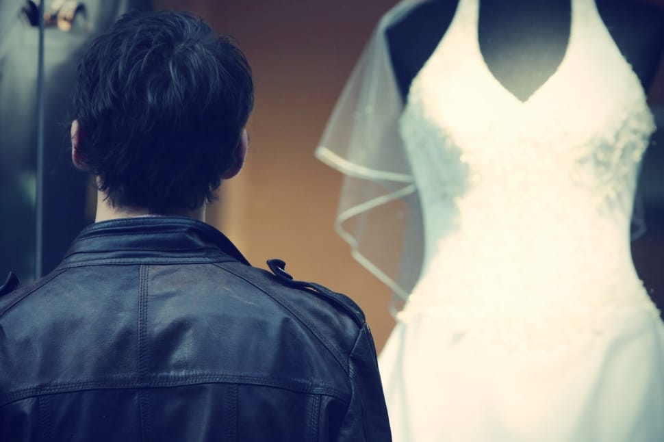 men's black leather jacket and women's white bridal gown preview