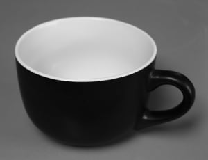 black and white ceramic coffee mug on gray textile thumbnail